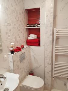 a white bathroom with a toilet and a sink at Kabana Suite Thessaloniki in Thessaloniki