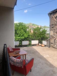 a patio with two chairs and a table and a view at L&A Guest House in Goris