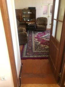 a hallway with a door open to a living room at L&A Guest House in Goris