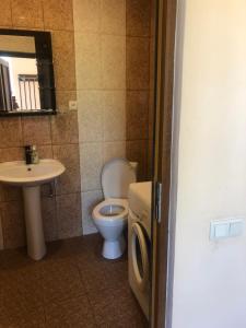 a bathroom with a toilet and a sink at L&A Guest House in Goris