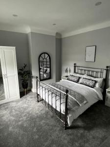 a bedroom with a large bed in a room at Quay Cottage in Parkgate