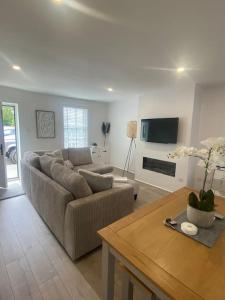 a living room with a couch and a table at Quay Cottage in Parkgate