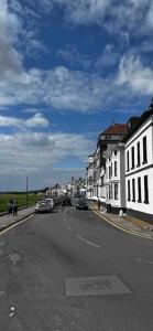a city street with cars parked on the side of the road at Quay Cottage in Parkgate