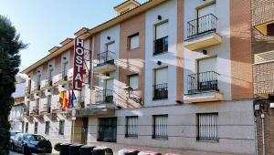 a building with a hotel sign on the side of it at Hostal Plaza Mayor in Torrejón de Ardoz