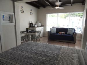 a bedroom with a bed and a table and a couch at Sands of Islamorada in Islamorada