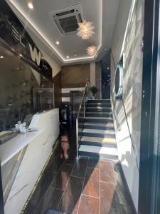 a lobby with a staircase in a building at Wheeler Hotel in Bronx