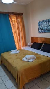 a hotel room with two beds with towels on the bed at Pension Irene in Sougia