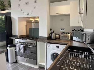 a kitchen with a washing machine and a washer at 2 bed sleeps 6 Beach retreat St Annes on sea in Lytham St Annes