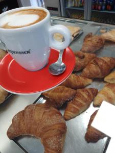 - une tasse de café et une assiette de pâtisseries dans l'établissement B&B Riccioli D'oro, à Margherita di Savoia