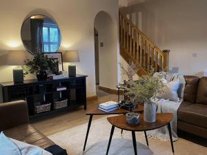 a living room with a couch and a table at Beautiful & cosy 4 bedroom home in Todmorden