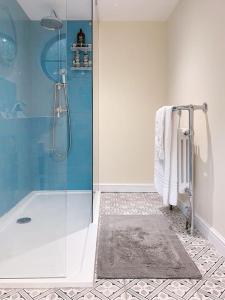 a bathroom with a shower and a glass shower stall at Beautiful & cosy 4 bedroom home in Todmorden