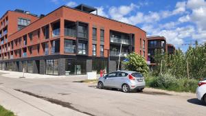 a silver car parked in front of a brick building at Old Town Nadmotławie - Sauna & Gym I 10min deptak in Gdańsk