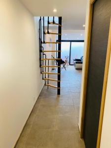 a hallway with a spiral staircase in a house at Douceur du sud in Vitrolles