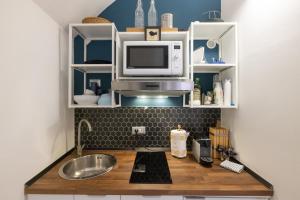 A kitchen or kitchenette at Rione Monti Studio Apt with private garden