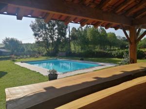 a swimming pool in a yard with a wooden deck at Two bedroom Stone Cottage in Condac