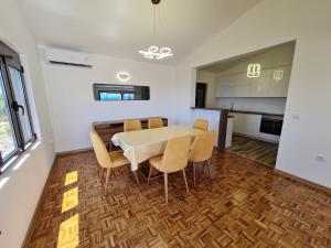 a kitchen and dining room with a table and chairs at Luxury Penthouse with panoramic view in Ulcinj