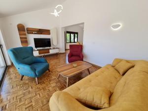 a living room with a couch and two chairs at Luxury Penthouse with panoramic view in Ulcinj
