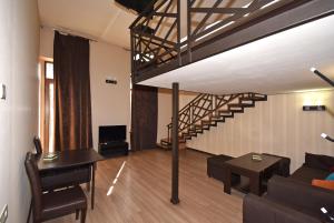a living room with a couch and a table and a staircase at Apartment Koryun 1 in Yerevan
