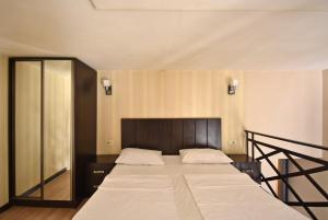 a bedroom with a large bed with a wooden headboard at Apartment Koryun 1 in Yerevan