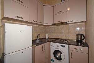 a kitchen with a white refrigerator and a washing machine at Apartment Koryun 1 in Yerevan