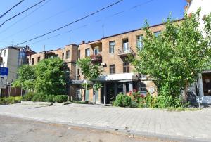an empty street in front of a brick building at Apartment Koryun 1 in Yerevan