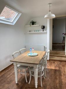 una sala da pranzo con tavolo e sedie in legno di Rustig appartement in het groen met terras a Kontich