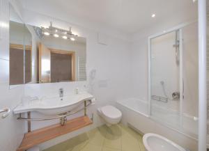 a bathroom with a sink and a toilet and a shower at Gabriel in Ortisei +11 photos