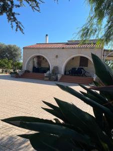 a building with a porch and a patio at Villa Gemma in San Vito dei Normanni