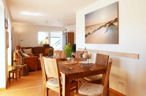 a dining room and living room with a table and chairs at Ferienwohnung Baabe Kapitan Blaubar Ref. (Ref.189689-1) in Baabe