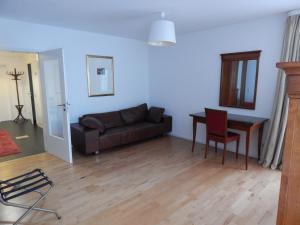 a living room with a couch and a table at FREE Apartment - Obere Wässere in Reutlingen