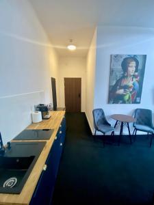 a room with a desk and two chairs and a table at Old Town Gertrudy Apartment - Topolove Rooms & Apartments in Krakow