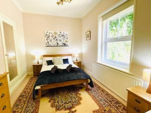 a bedroom with a bed and a large window at Lottie's Lookout, Ventnor with fantastic Sea Views in Ventnor