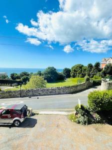 a car parked on the side of a road at Lottie's Lookout, Ventnor with fantastic Sea Views in Ventnor