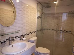 a bathroom with a toilet and a sink and a shower at VANDA Hotel Nha Trang in Nha Trang +37 photos