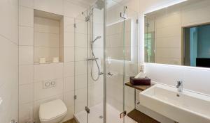 a bathroom with a shower and a toilet and a sink at Europa Hotel Kühlungsborn in Kühlungsborn