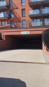 a parking garage in front of a building at Old Town Nadmotławie - Sauna & Gym I 10min deptak in Gdańsk