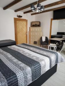 a bedroom with a bed and a living room at Patak28 Apartmanok in Sopron