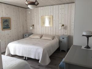 a bedroom with a bed and two tables and a lamp at Fjällhus i Funäsdalen in Funäsdalen