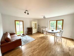 a living room with a couch and a table at Ferienwohnung Grafenau Schönau in Schönau am Königssee