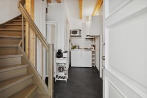 a small kitchen and stairs in a tiny house at Urban city home in Berlin