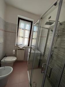 a bathroom with a toilet and a sink and a shower at Villa Romina esclusive cottage Gissi in Gissi