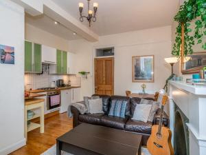 a living room with a couch and a guitar at Pass the Keys Superb 1 Bed Flat in Traditional Victorian Building in Edinburgh