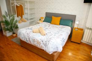 a bedroom with a bed with two pillows on it at Loft " La fábrica de Gas",PARKING in Oviedo