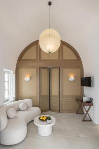 a living room with a couch and a table at Aspaki by Art Maisons in Oia