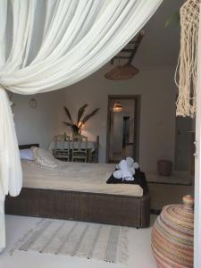 a bedroom with a bed with a white canopy at KD Boho Home in Lavrio