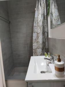 a bathroom with a sink and a shower at KD Boho Home in Lávrion