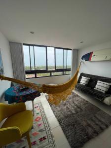 ein Zimmer mit einer Hängematte in der Mitte eines Zimmers in der Unterkunft São João Beach Lounge in Costa da Caparica