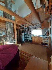 a large room with a bed and a kitchen at Dīķīši in Daugavpils