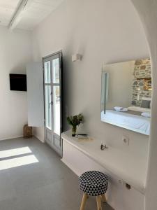 a white room with a bed and a mirror at Thomas Villas on the beach Katapola in Katapola +37 photos