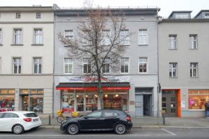 a black car parked in front of a building at Arbio I Urban Apartment in Berlin